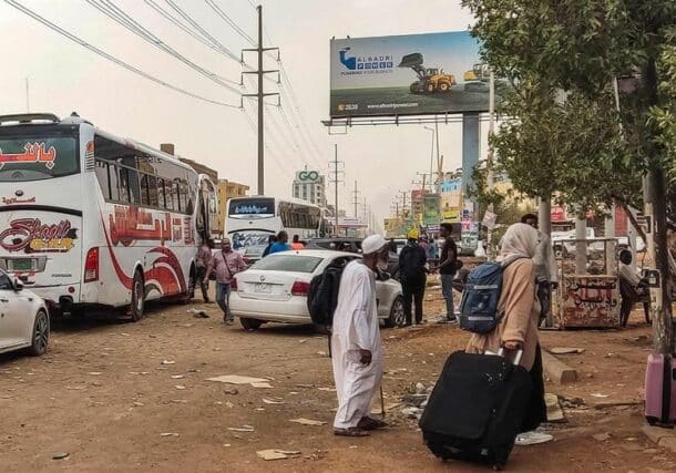 People prepare to board a bus departing from Khartoum in the Sudanese capital's south on April 24, 2023, AFP