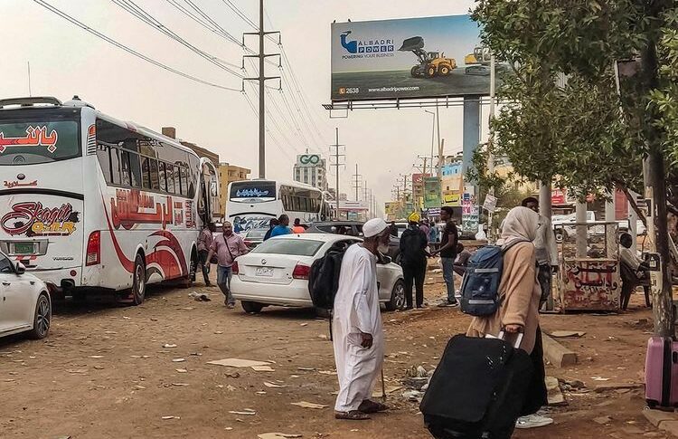 People prepare to board a bus departing from Khartoum in the Sudanese capital's south on April 24, 2023, AFP