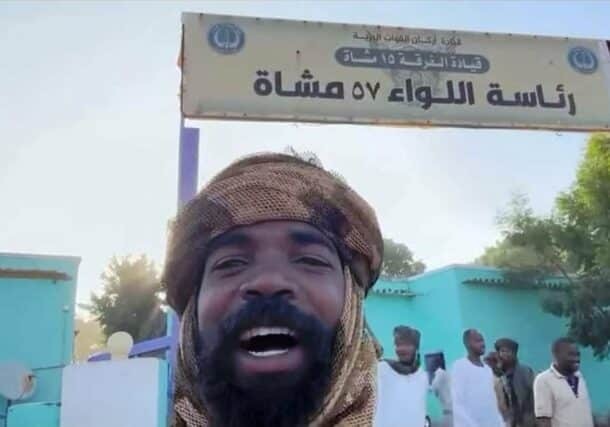 RSF fighter poses at the entrance of the army headquarters in El Geneina on November 4, 2023