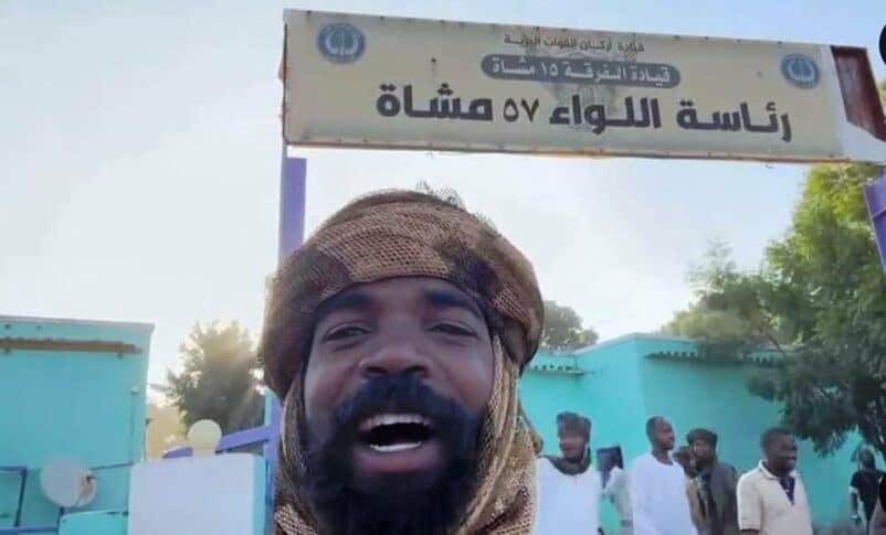 RSF fighter poses at the entrance of the army headquarters in El Geneina on November 4, 2023