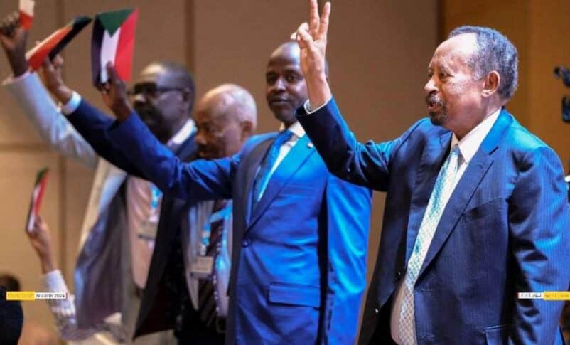 Hamdok and some of Tagadum leaders raise their hands at the opening session of their three-day meeting on May 27, 2024